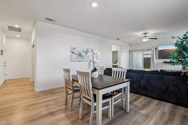 a view of a dining room with furniture and wooden floor