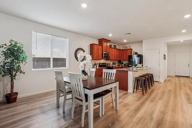 a view of a dining room with furniture and wooden floor