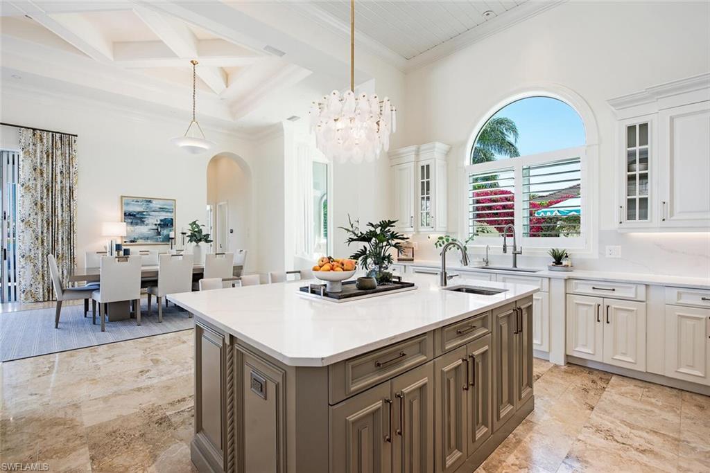 13741 Pondview Circle Naples, FL 34119 - Photo 11 of 50 a kitchen with a sink a stove and cabinets