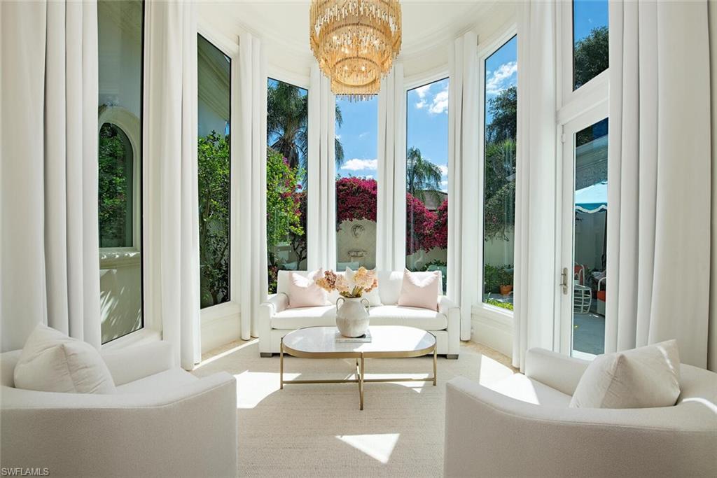 13741 Pondview Circle Naples, FL 34119 - Photo 12 of 50 a living room with furniture and a large window