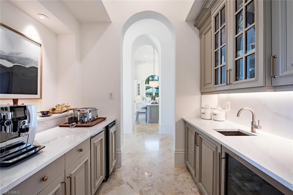 13741 Pondview Circle Naples, FL 34119 - Photo 14 of 50 a kitchen with a sink and a stove top oven