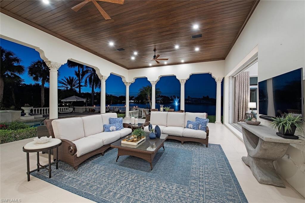 13741 Pondview Circle Naples, FL 34119 - Photo 17 of 50 a living room with patio furniture and a flat screen tv
