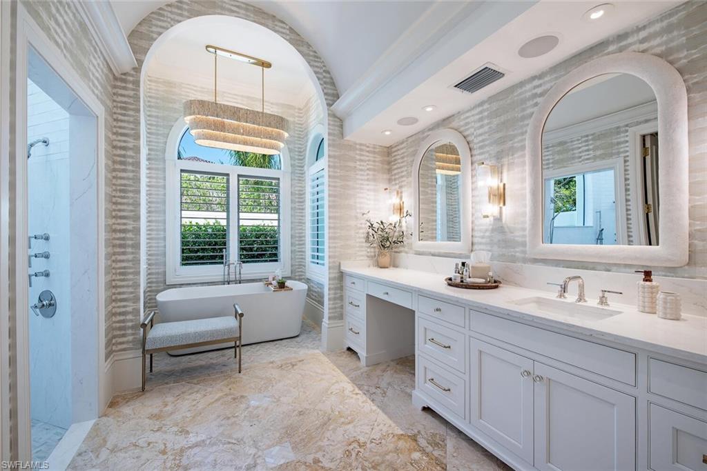 13741 Pondview Circle Naples, FL 34119 - Photo 24 of 50 a spacious bathroom with a double vanity sink a mirror and next to a window