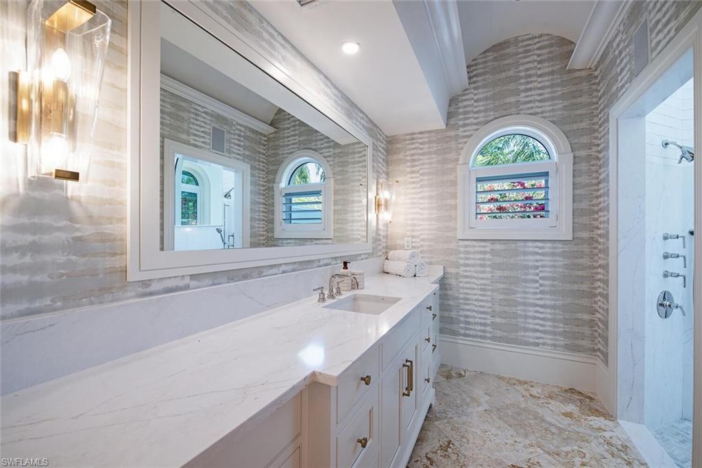 13741 Pondview Circle Naples, FL 34119 - Photo 26 of 50 a bathroom with a sink and a mirror