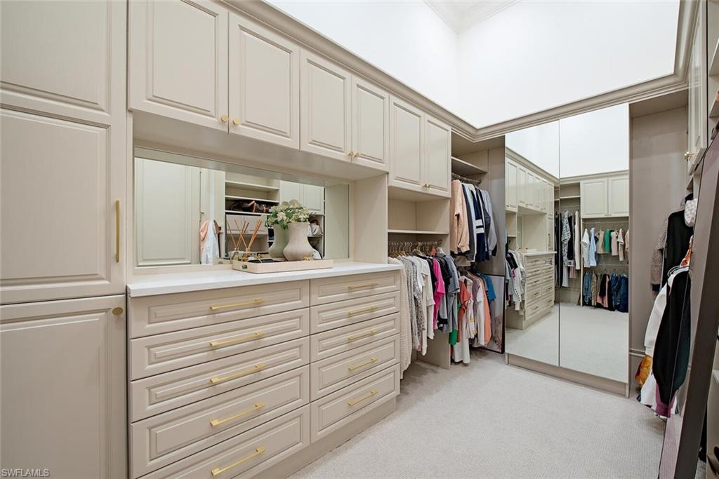 13741 Pondview Circle Naples, FL 34119 - Photo 28 of 50 a bathroom with a double vanity sink and a walk in closet