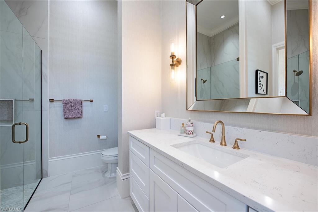 13741 Pondview Circle Naples, FL 34119 - Photo 35 of 50 a bathroom with a sink a toilet and shower