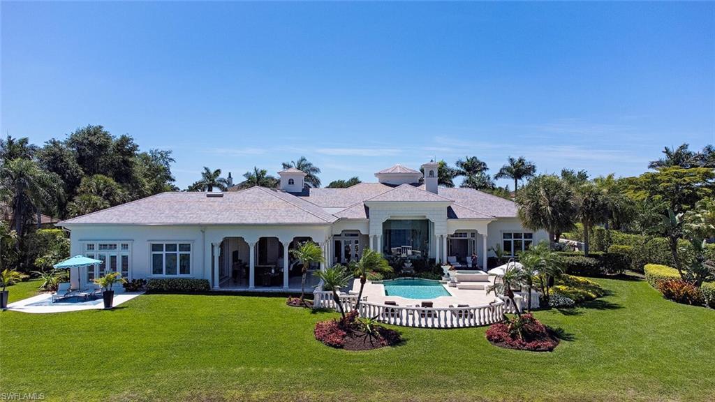 13741 Pondview Circle Naples, FL 34119 - Photo 38 of 50 a front view of a house with garden and porch