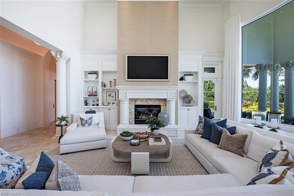 13741 Pondview Circle Naples, FL 34119 - Photo 4 of 50 a living room with furniture a flat screen tv and a fireplace