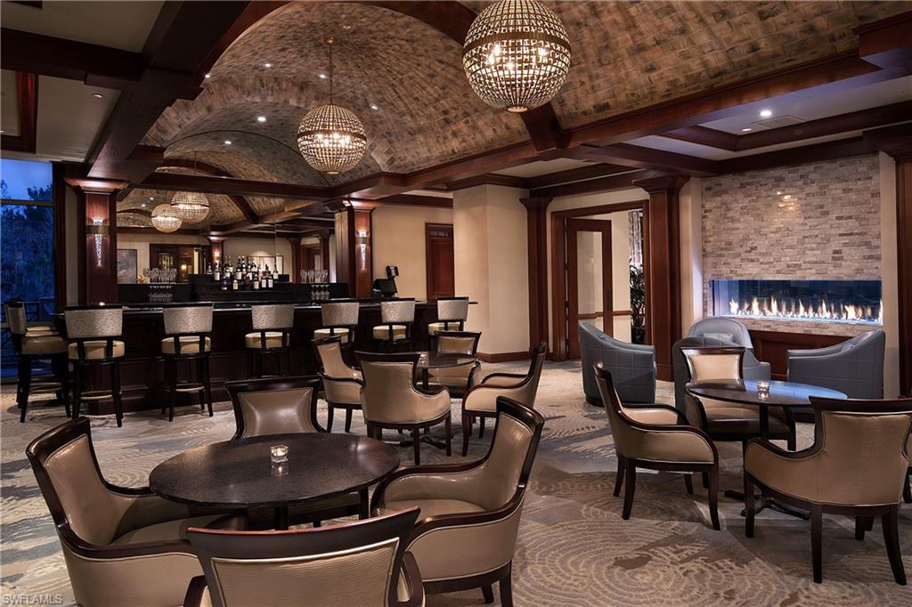 13741 Pondview Circle Naples, FL 34119 - Photo 47 of 50 a room with lots of chairs and a chandelier