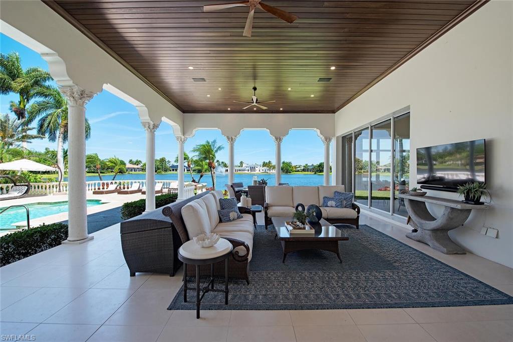 13741 Pondview Circle Naples, FL 34119 - Photo 5 of 50 a living room with patio furniture and a flat screen tv