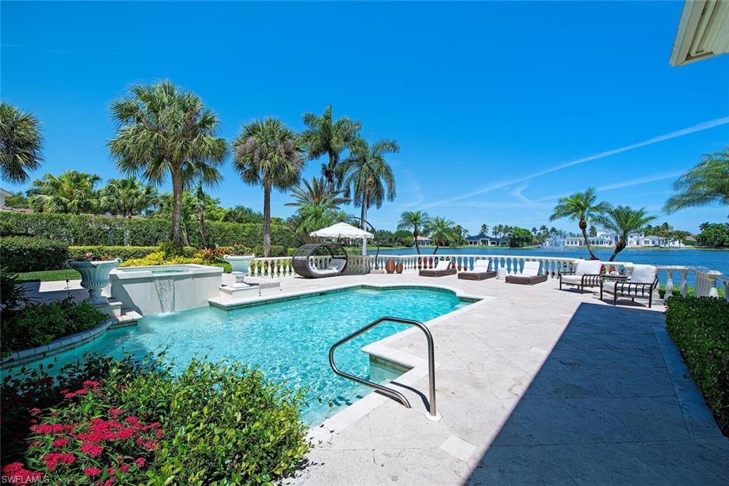 13741 Pondview Circle Naples, FL 34119 - Photo 6 of 50 a view of a swimming pool and lounge chair