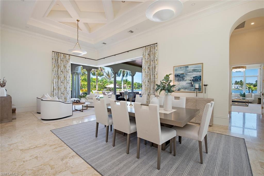 13741 Pondview Circle Naples, FL 34119 - Photo 9 of 50 a view of a dining room with furniture window and wooden floor