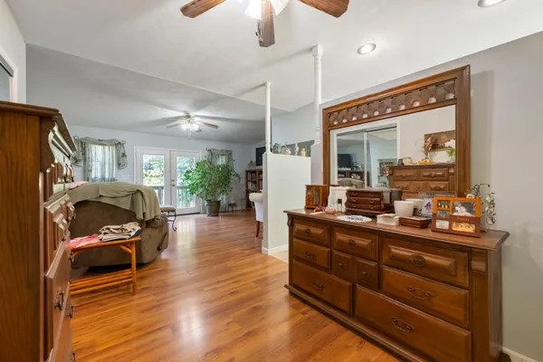 a balcony with wooden floor and yard in the back