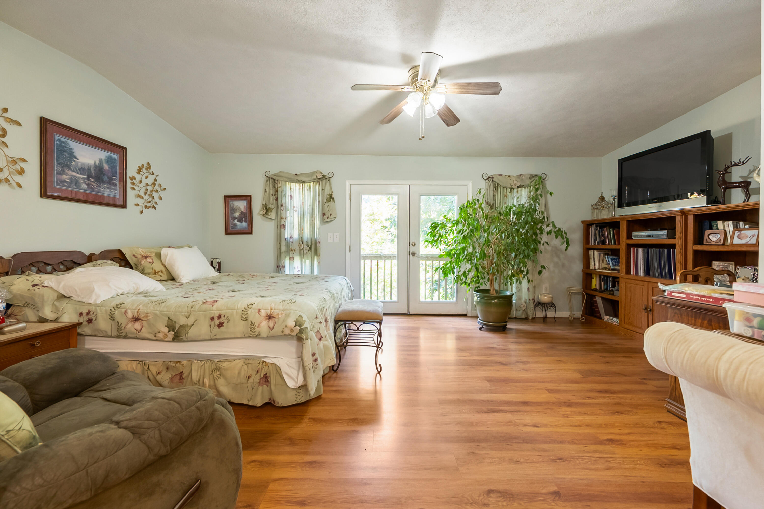 6286 Chestnut Ridge Road Riner, VA 24149 - Photo 30 of 102 a bedroom with a large bed and a flat screen tv