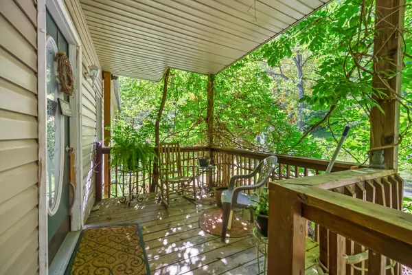 a view of a patio with a table and chairs under an umbrella