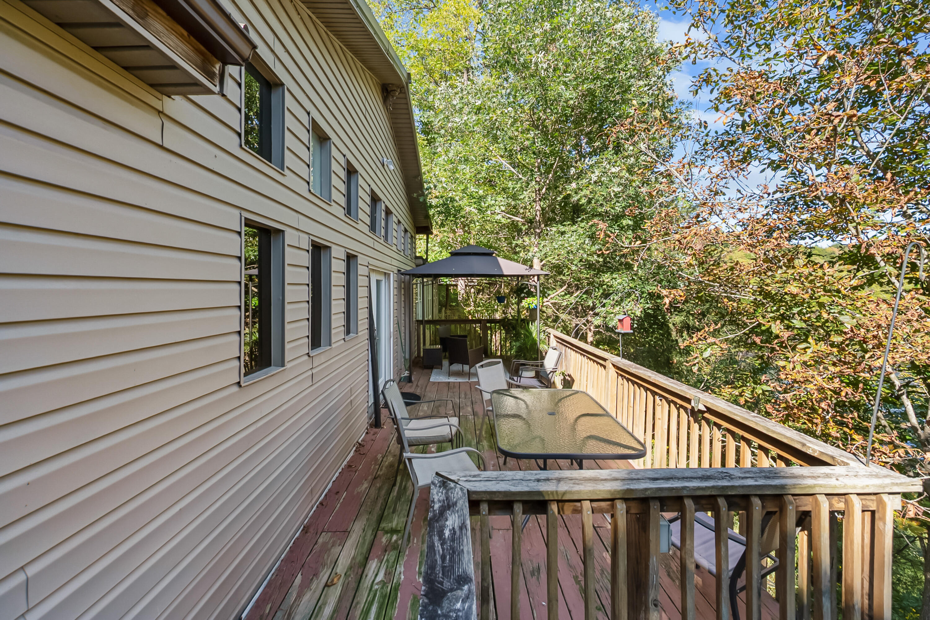 6286 Chestnut Ridge Road Riner, VA 24149 - Photo 42 of 102 a balcony with wooden floor and outdoor seating