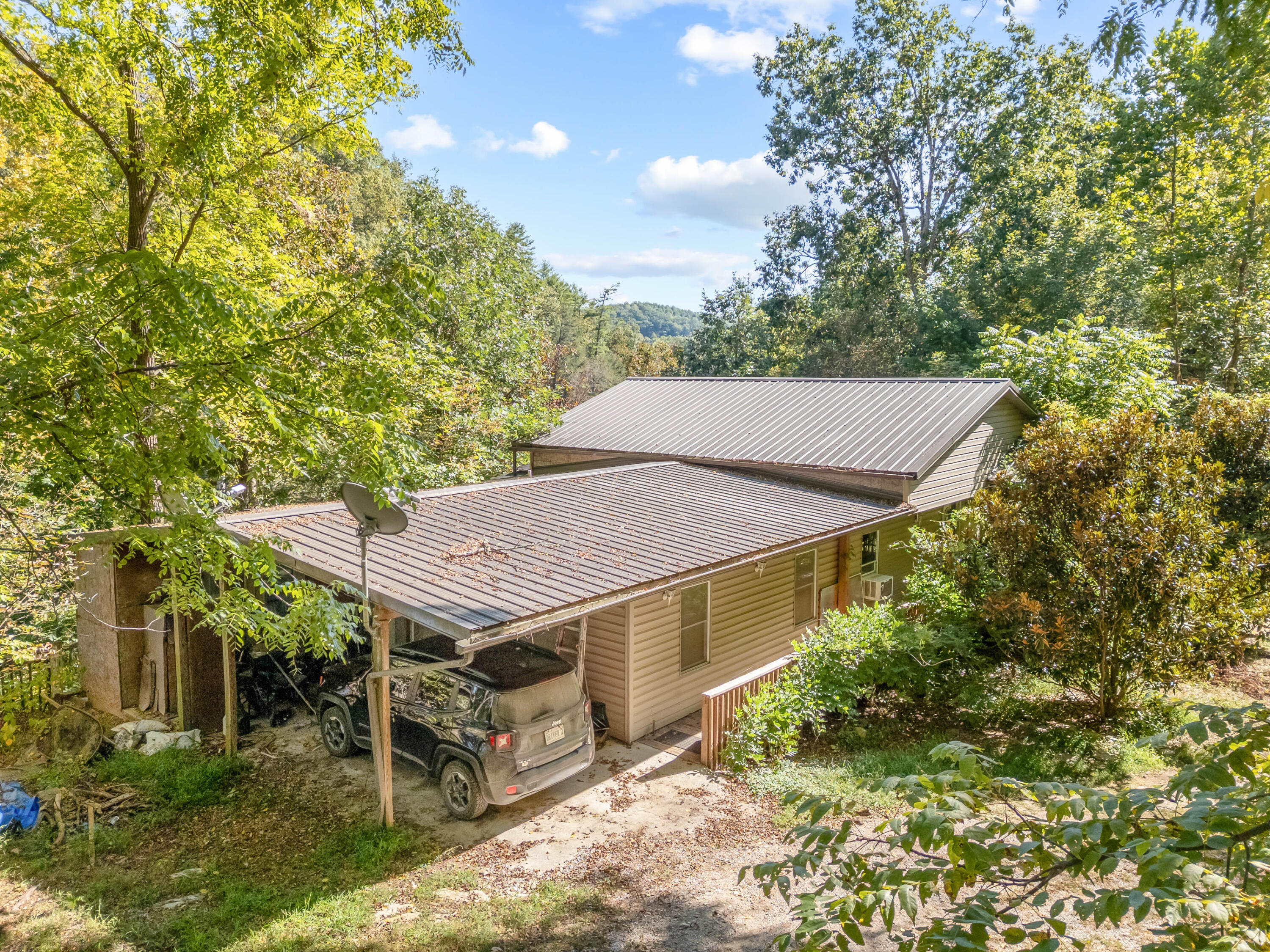 6286 Chestnut Ridge Road Riner, VA 24149 - Photo 7 of 102 a view of a patio with a table and chairs under an umbrella