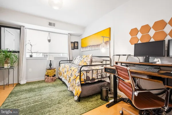 a bedroom with furniture and a window