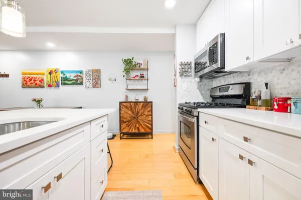 a kitchen with stainless steel appliances a stove a microwave and cabinets