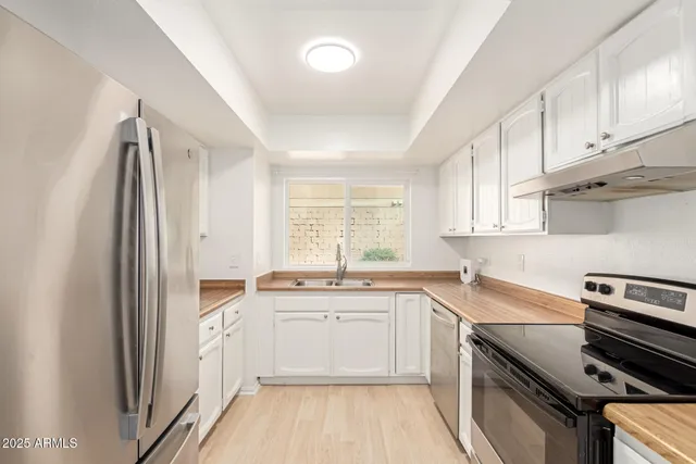 a kitchen with a sink stove and cabinets