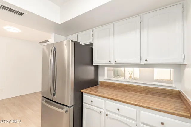 a kitchen with cabinets and stainless steel appliances