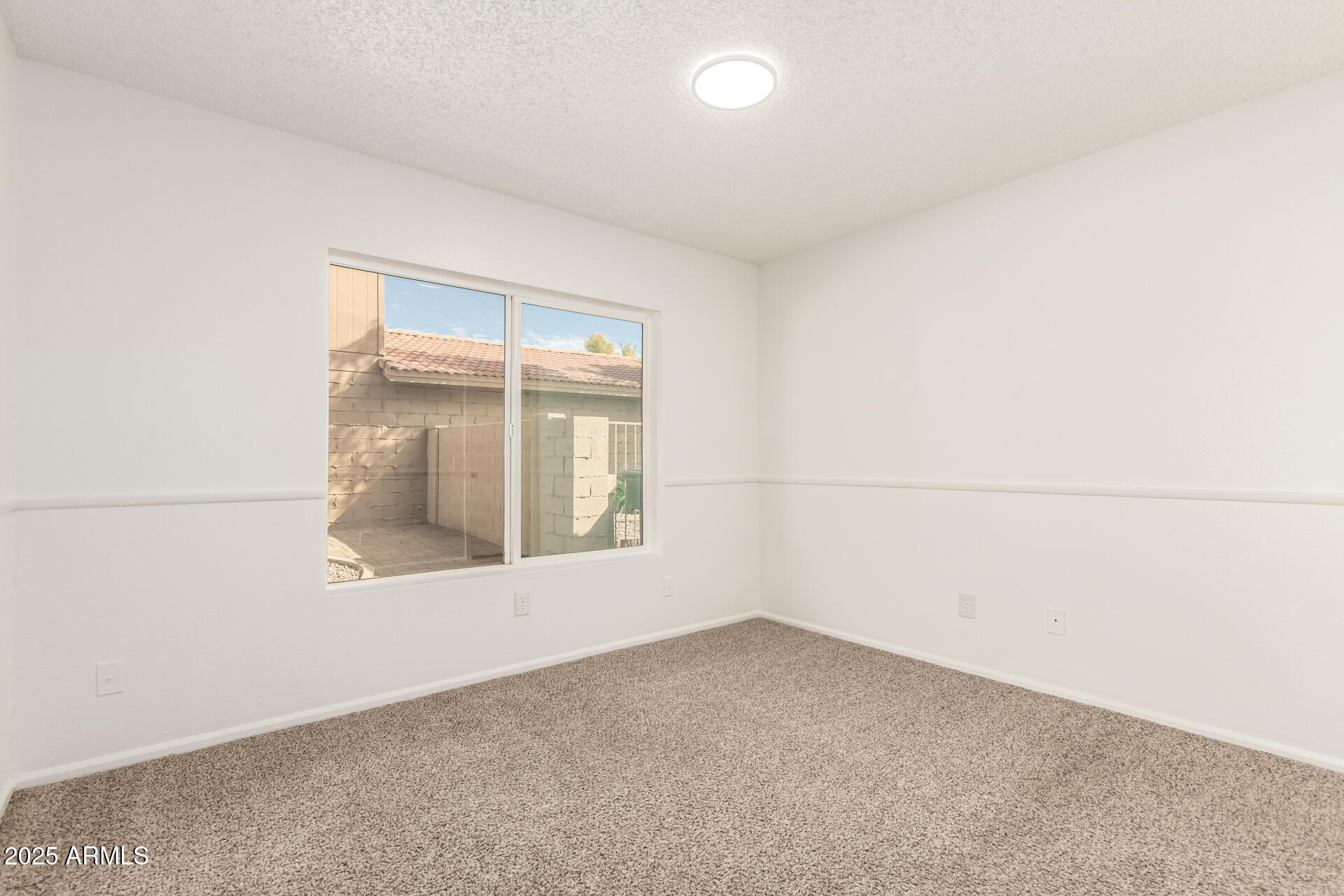 2702 West Brooks Street Chandler, AZ 85224 - Photo 32 of 41 an empty room with a window