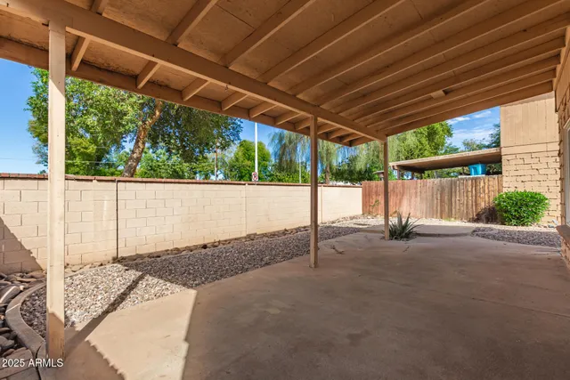 a backyard of a house with a shaded area