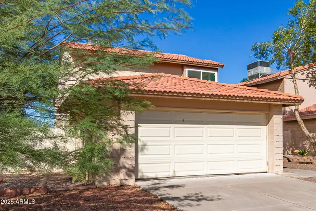 a view of a house with a yard and garage