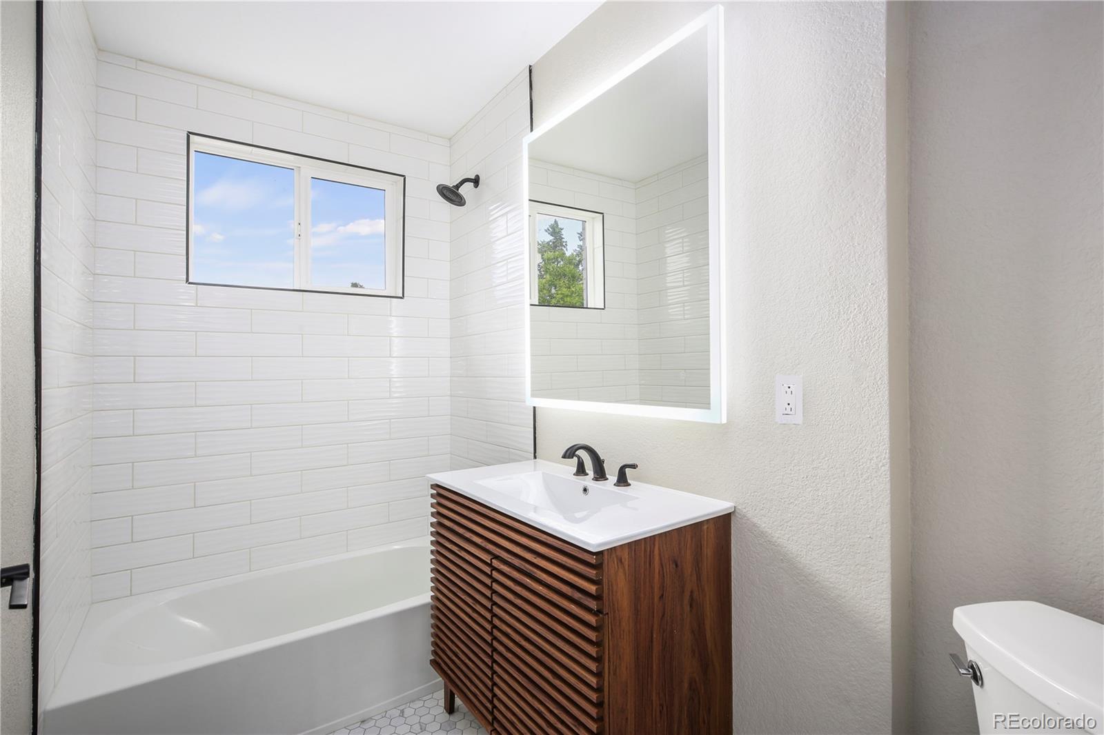 4334 North Decatur Street Denver, CO 80211 - Photo 14 of 26 a bathroom with a sink and a bathtub