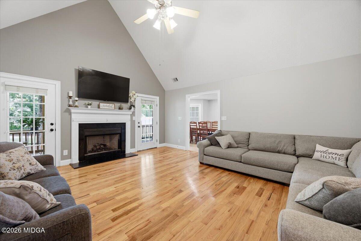 557 Aarons Circle Gray, GA 31032 - Photo 7 of 36 a living room with furniture a fireplace and a flat screen tv