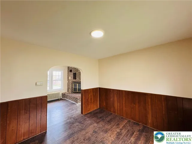 a view of a room with wooden floor