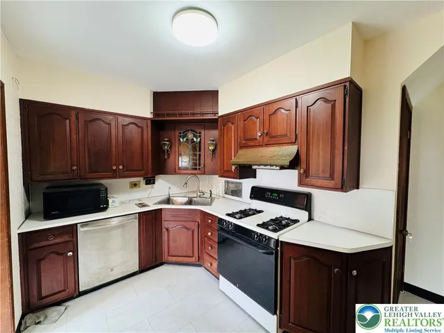 a kitchen with cabinets a sink and appliances