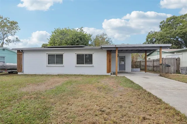 a front view of house with yard and trees