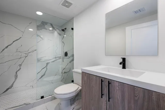 a bathroom with a sink toilet and shower