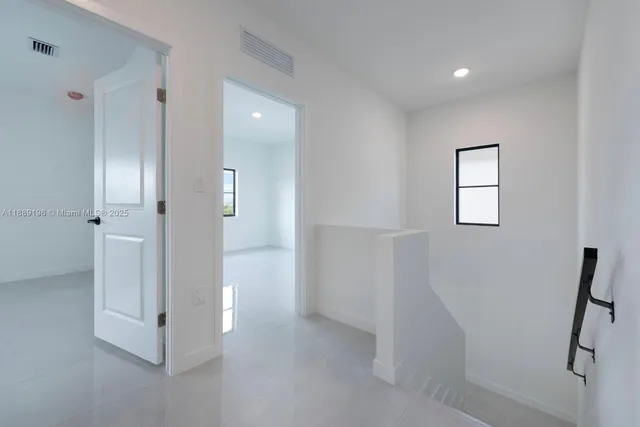 a view of a hallway with closet and mirror