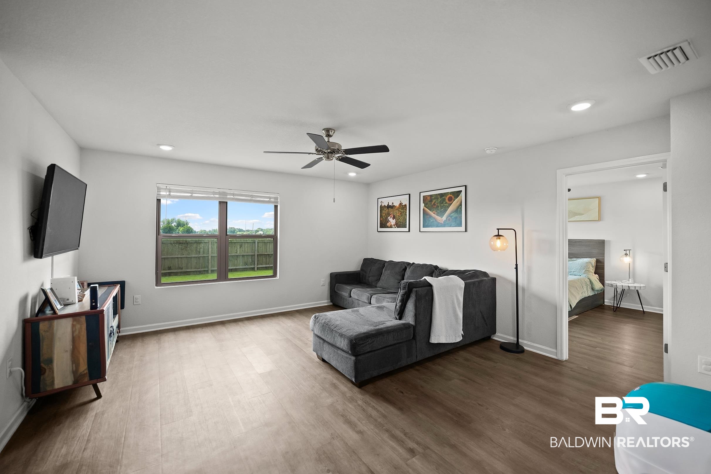 32030 Terranova Loop Lillian, AL 36549 - Photo 3 of 30 Spacious living area featuring wood-finish flooring, recessed lighting, and a ceiling fan