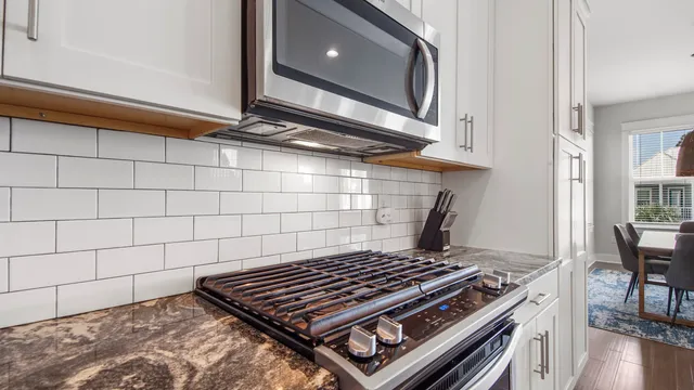 a stove top oven sitting inside of a kitchen