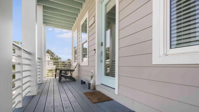 a view of balcony with wooden floor and furniture