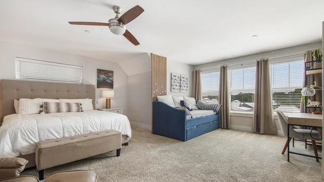 a bedroom with a bed and a large window