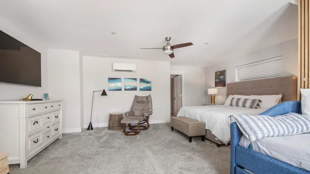 a bedroom with furniture and a flat screen tv