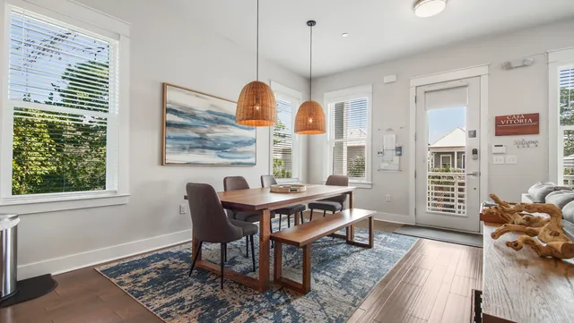 a living room with furniture a window and a wooden floor