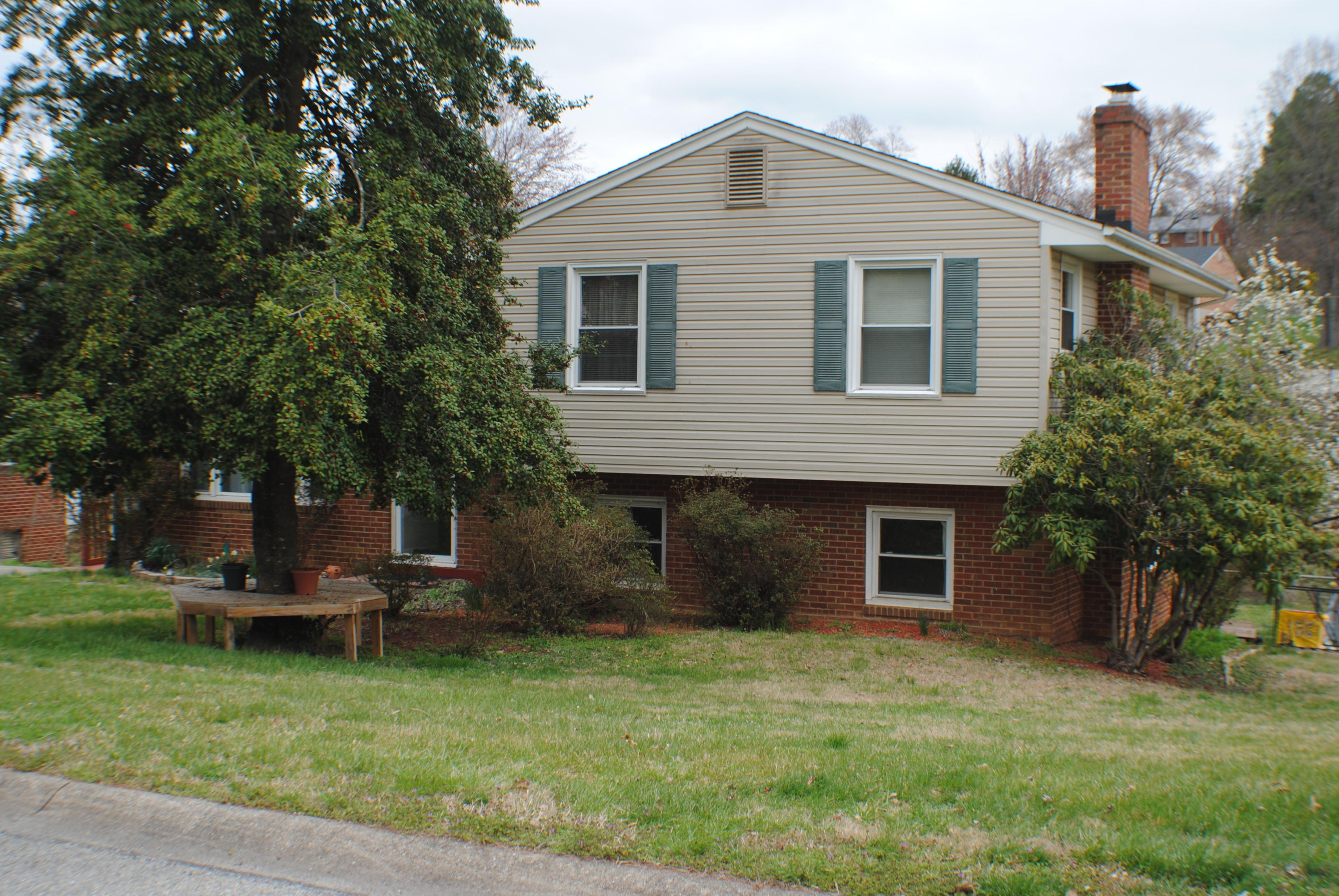 a front view of house with a garden