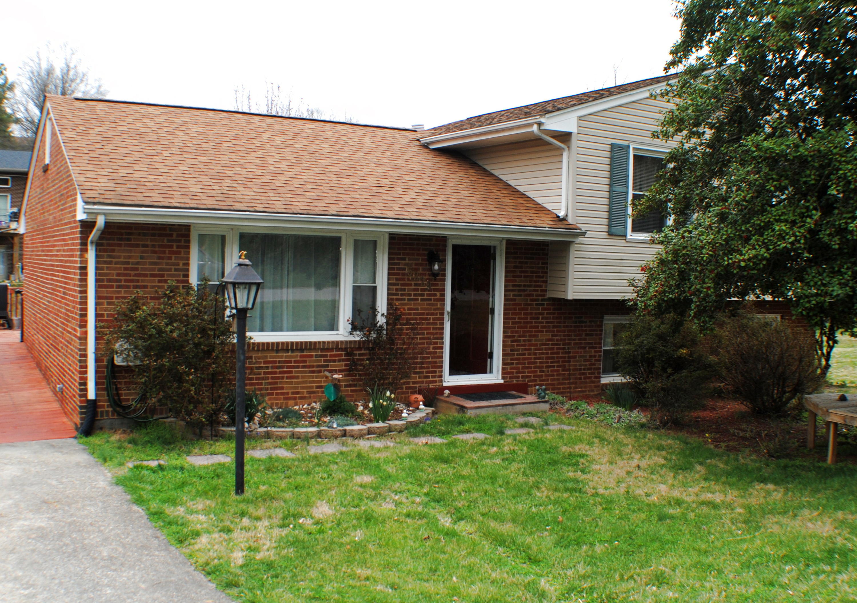 5229 Cave Spring Lane Roanoke, VA 24018 - Photo 2 of 49 a front view of a house with a garden and yard