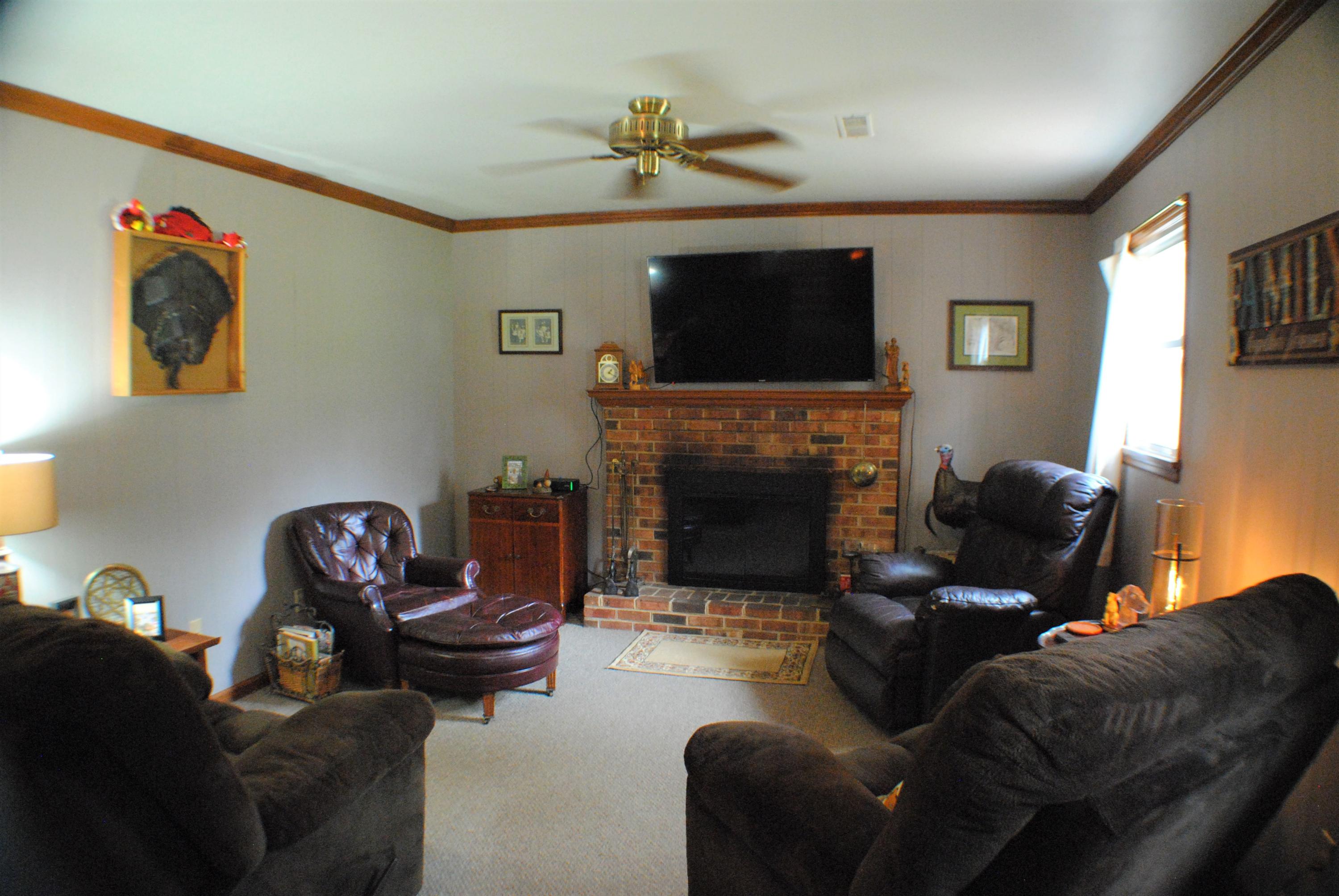 5229 Cave Spring Lane Roanoke, VA 24018 - Photo 15 of 49 a living room with furniture a flat screen tv and a fireplace