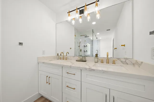 a bathroom with a sink double vanity and a mirror