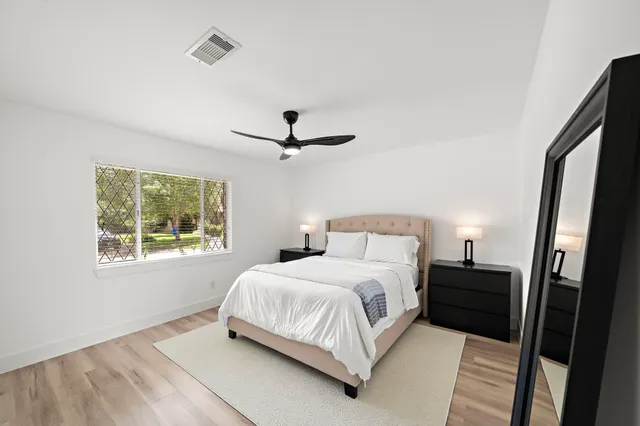 a bedroom with a bed and a window