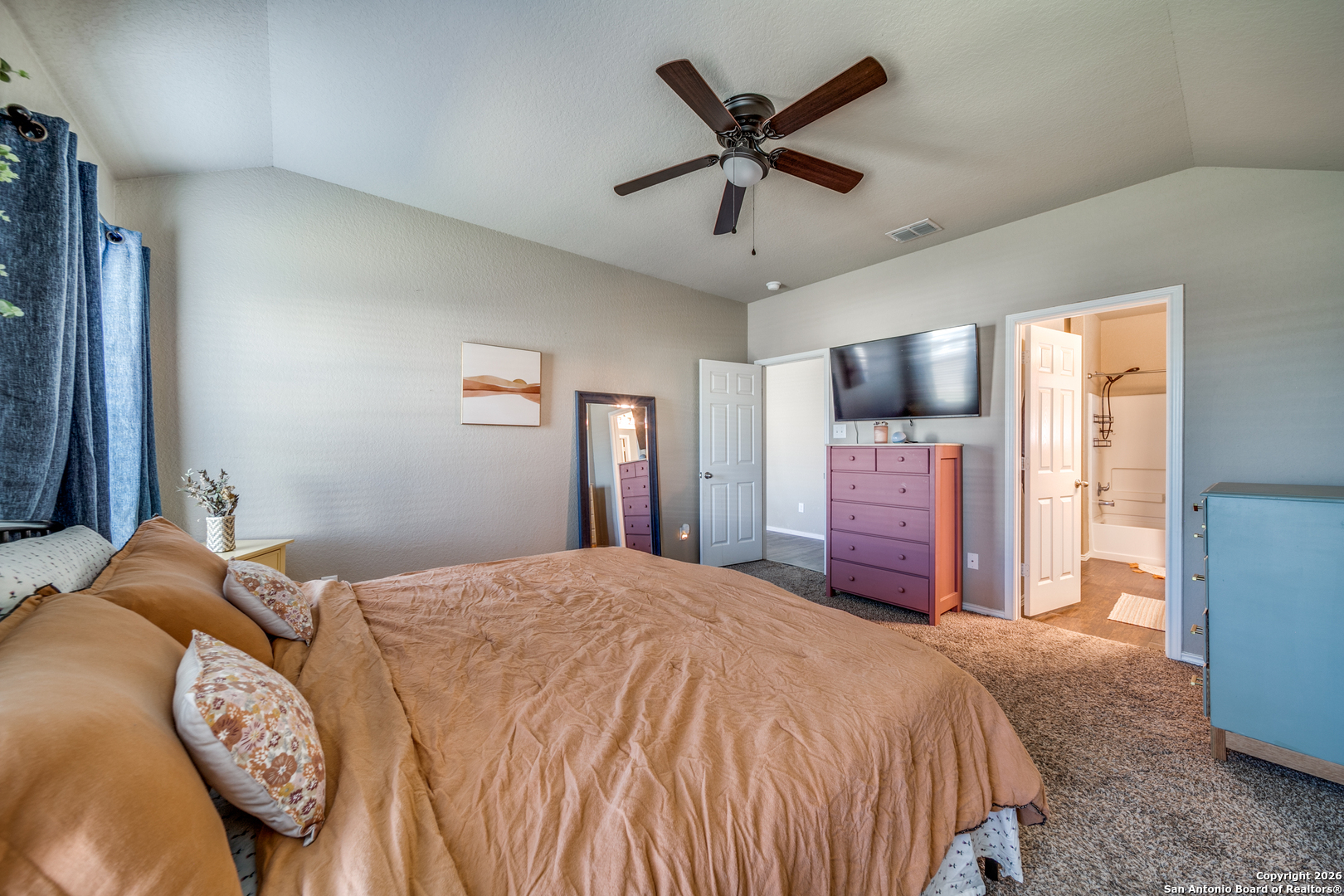 7211 Marina Del Rey Converse, TX 78109 - Photo 21 of 25 a bedroom with a large bed and a chandelier