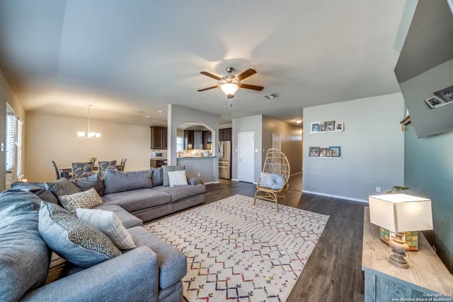 a living room with furniture and wooden floor