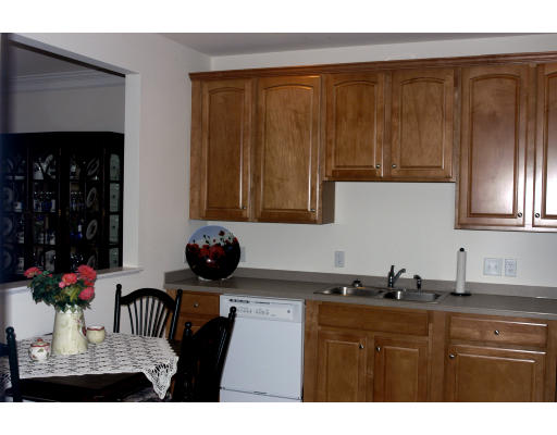 170 Haverhill Street, Unit 138 Andover, MA 01810 - Photo 4 of 16 a kitchen with a sink refrigerator and cabinets
