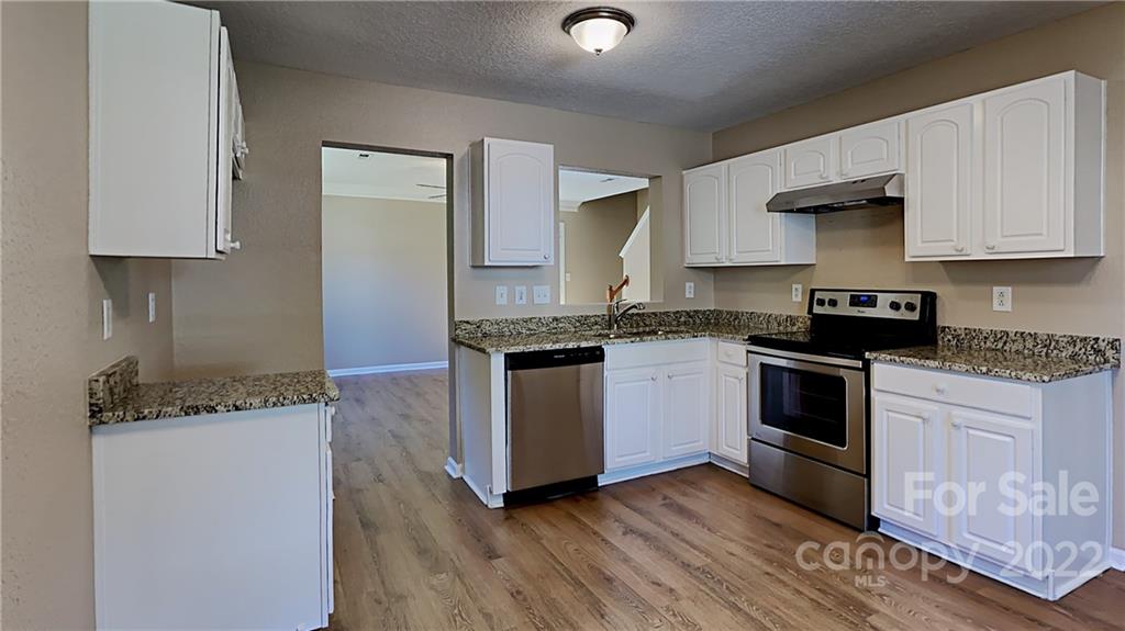 701 Raindrops Road Gastonia, NC 28054 - Photo 11 of 14 a kitchen with granite countertop a sink stainless steel appliances and cabinets